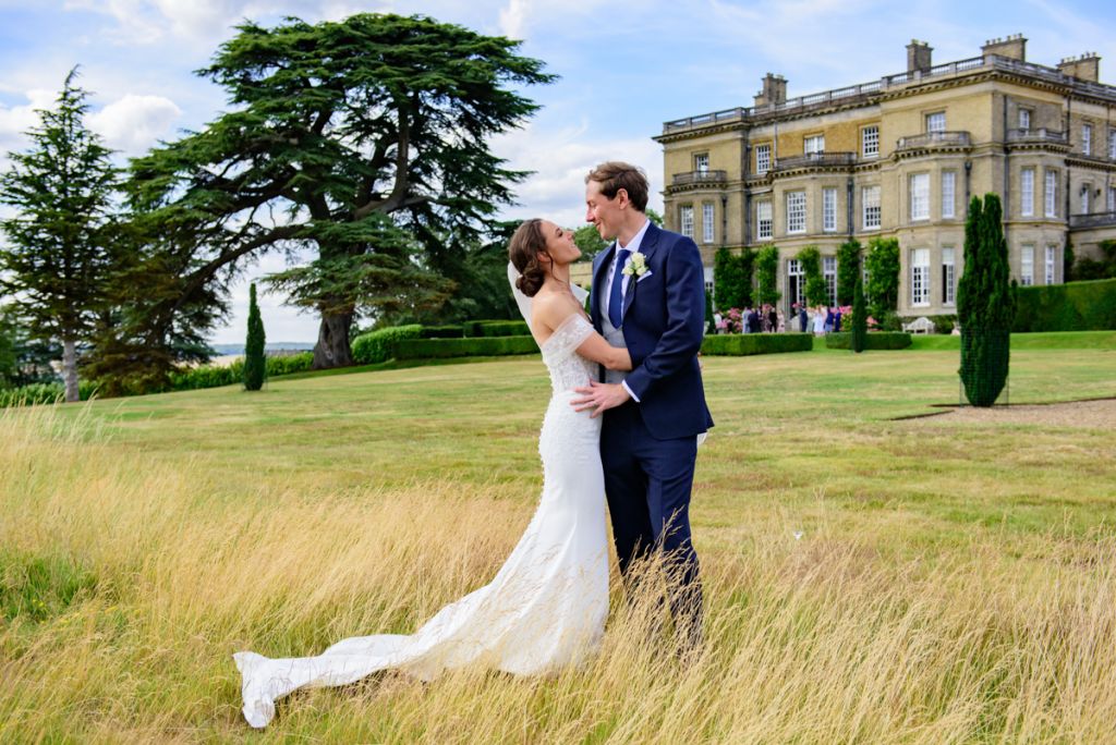 Bride and Groom embrace in Garden outside Hedsor House.